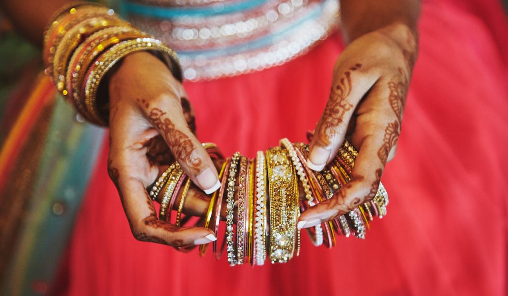 indian woman holding her different lac bangles