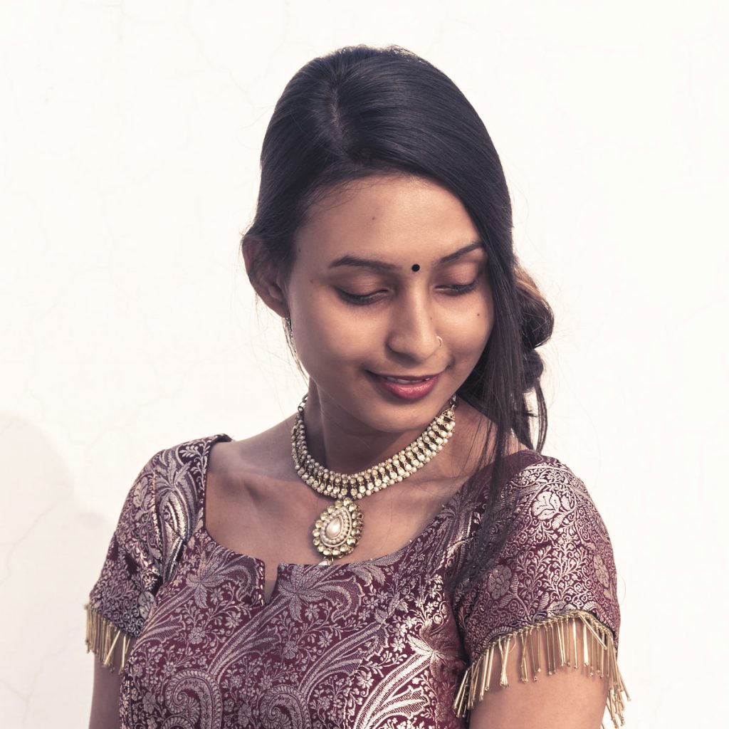 indian young woman in ethnic dress and kundan jewellery necklace