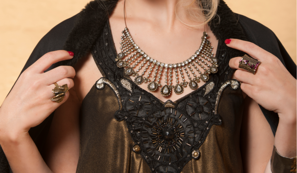 beautiful blonde woman showing her Byzantine jewelry necklace and rings