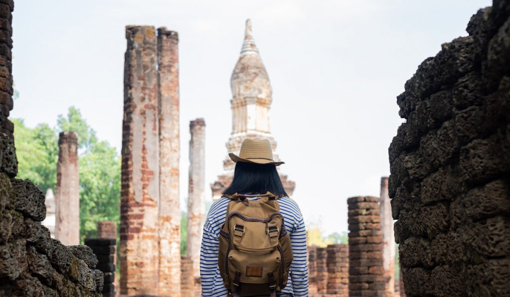 woman staying at ancient of pagoda temple archaeological site